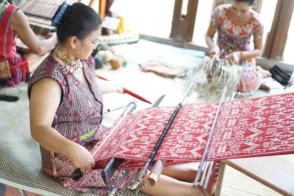 Local people making songket in Palembang