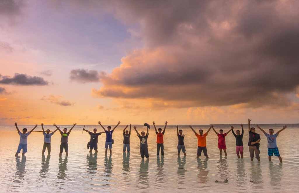 A group traveler enjoying sunset in Tanjung Bira