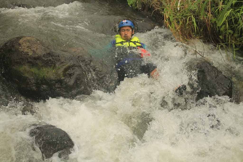 Passing through rapids on river tubing activity